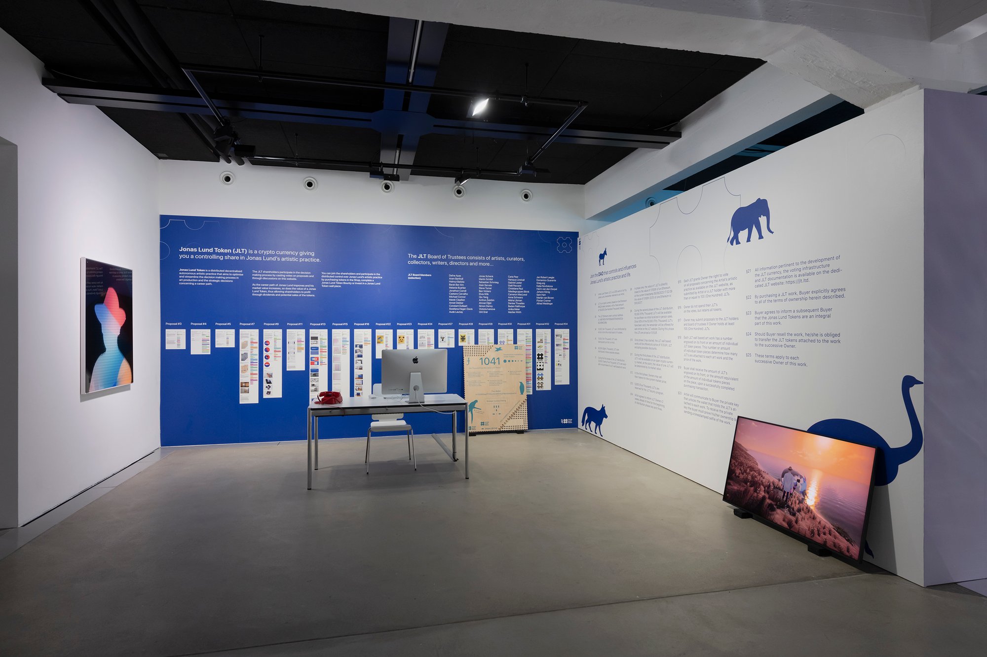 Installation view of “Collective Worldbuilding — Art in the Metaverse,” at HEK with works: Jonas Lund, Red Telephone (2020); Optimisation Strategy (2020); Jonas Lund Token (JLT) 1041 (2019); Walk with Me (2022). Photography by Franz Wamhof. Courtesy of HEK Basel
