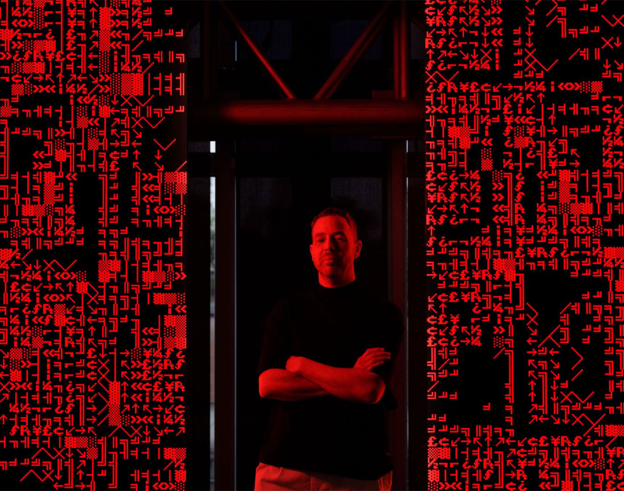 Andreas Gysin, Lattice, 2025. The artist with his work on show at Institut du Monde Arabe, Paris, in February 2025, before Lattice joined the collection of Arab Bank Switzerland, in Geneva. Photograph via linkedin.com/arab-bank-switzerland. Courtesy of the artist and Arab Bank Switzerland